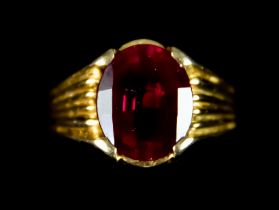 An 18ct Gold Faceted Ruby Ring, with fluted shank set with a faceted ruby stone, approximately