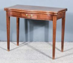 A George III Mahogany Rectangular Tea Table of serpentine outline, with moulded edge to top,