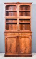 A Victorian Mahogany Bookcase, the upper part with moulded cornice and carved shell cresting, fitted