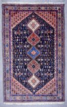 An Early 20th Century Shiraz Rug woven in colours of ivory, navy blue and wine, with five hooked