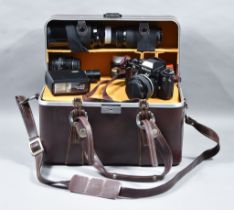 A 35mm Camera by Nikon, model F3, with lenses and some accessories, in brown leatherette case for