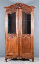 A 19th Century French Provincial Oak Armoire, with moulded cornice, the frieze carved with vase of