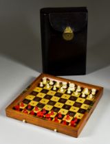 A Late 19th Century Travelling Chess Set, by J. Jacques and Son, Makers, London, the hinged mahogany