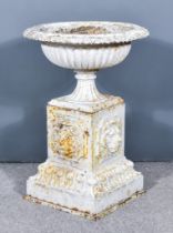 A White Painted Cast Iron Garden Urn, Early 20th Century, with reeded body, on square plinth base