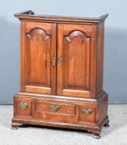 A George III Mahogany Spice Cupboard, the upper part with moulded cornice, fitted fifteen small