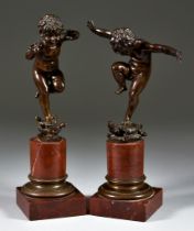 19th Century Continental School - Pair of brown patinated bronze figures - Putti, each standing on a