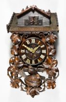 A 19th Century Carved and Stained Wood Black Forest Cuckoo Clock, with labels for Kamerer Cuss,