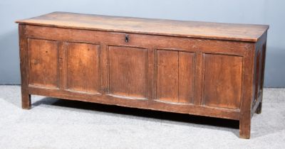 A Late 17th Century Panelled Oak Coffer, with two plank top, the front with five folded panels and