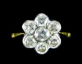 An 18ct Gold Diamond Cluster Ring, set with seven diamonds in a flower head design, approximately