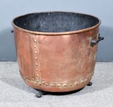 A Victorian Copper Copper, of large proportions, with rivetted sides and base, on brass paw feet,