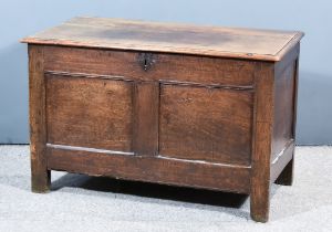 A Late 17th Century Panelled Oak Coffer, the two-plank top with moulded edge, enclosing candle