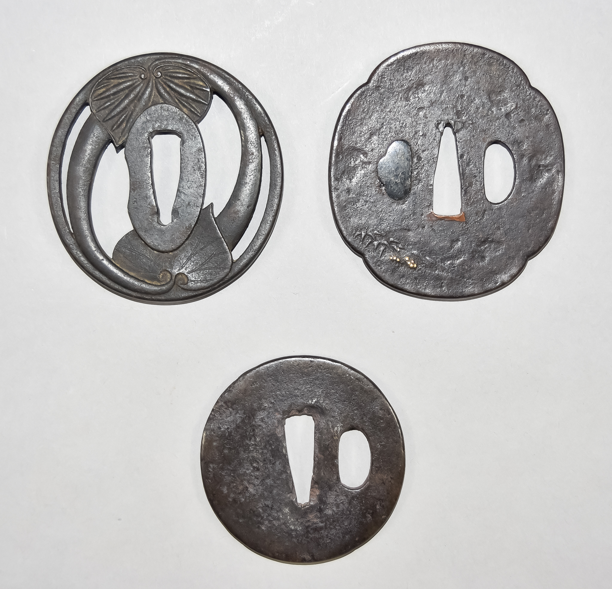 Fifteen Japanese Tsuba, some with fretted iron work designs, three with decorated iron work, some