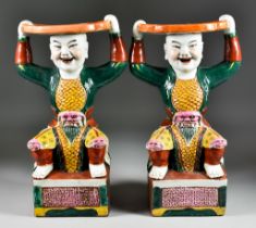 A Pair of Chinese Figural Stands, 20th Century, modelled in the form of fighting warriors holding