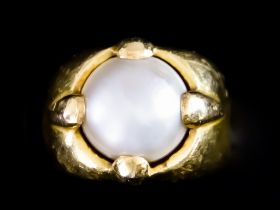 A Yellow Metal Ring, set with a button pearl, size M, gross weight 11.9g Note: Ring marked 850