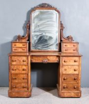 A Victorian Figured Walnut Kneehole Dressing Table, surmounted by mirror with moulded frame, shell