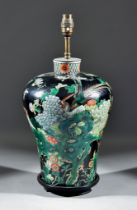 A Chinese Famille Noire Porcelain Baluster-Shaped Vase, enamelled with rockwork and flowering