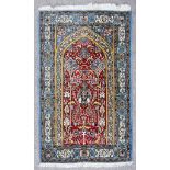 A Fine Isfahan Prayer Rug, Mid-20th Century, woven in colours of wine, ivory and blue, with a