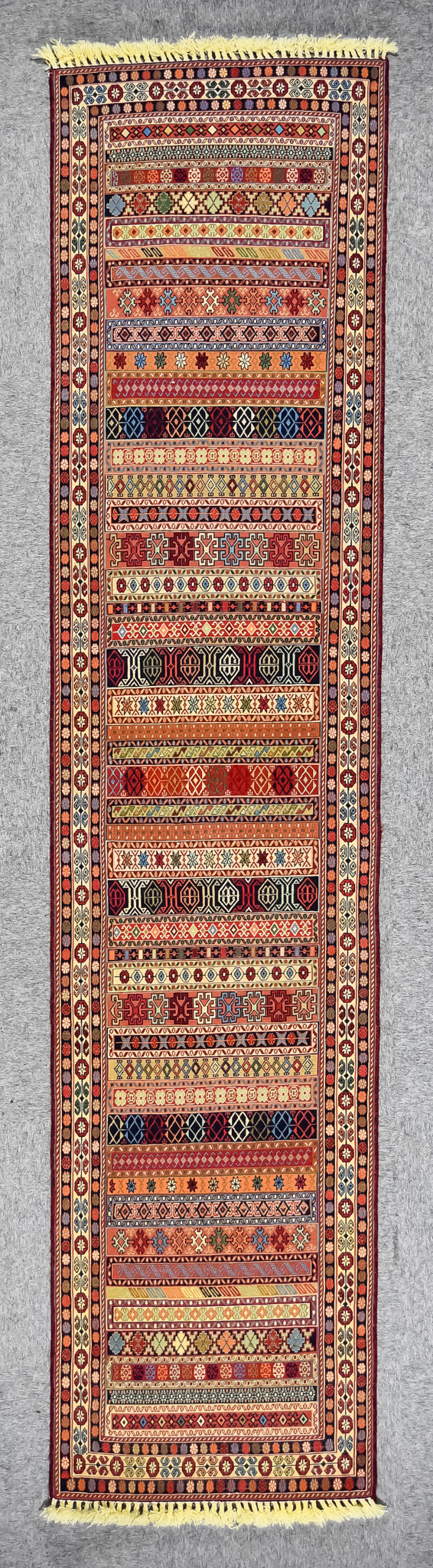 A 20th Century Kerman (Sirjan-Afshar) Runner, woven in colours of ivory, navy blue, wine, fawn,