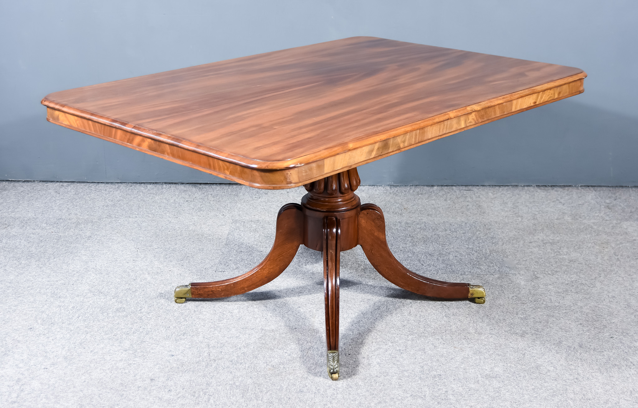 An Early Victorian Figured Mahogany Rectangular Breakfast Table, with moulded edge to top, on