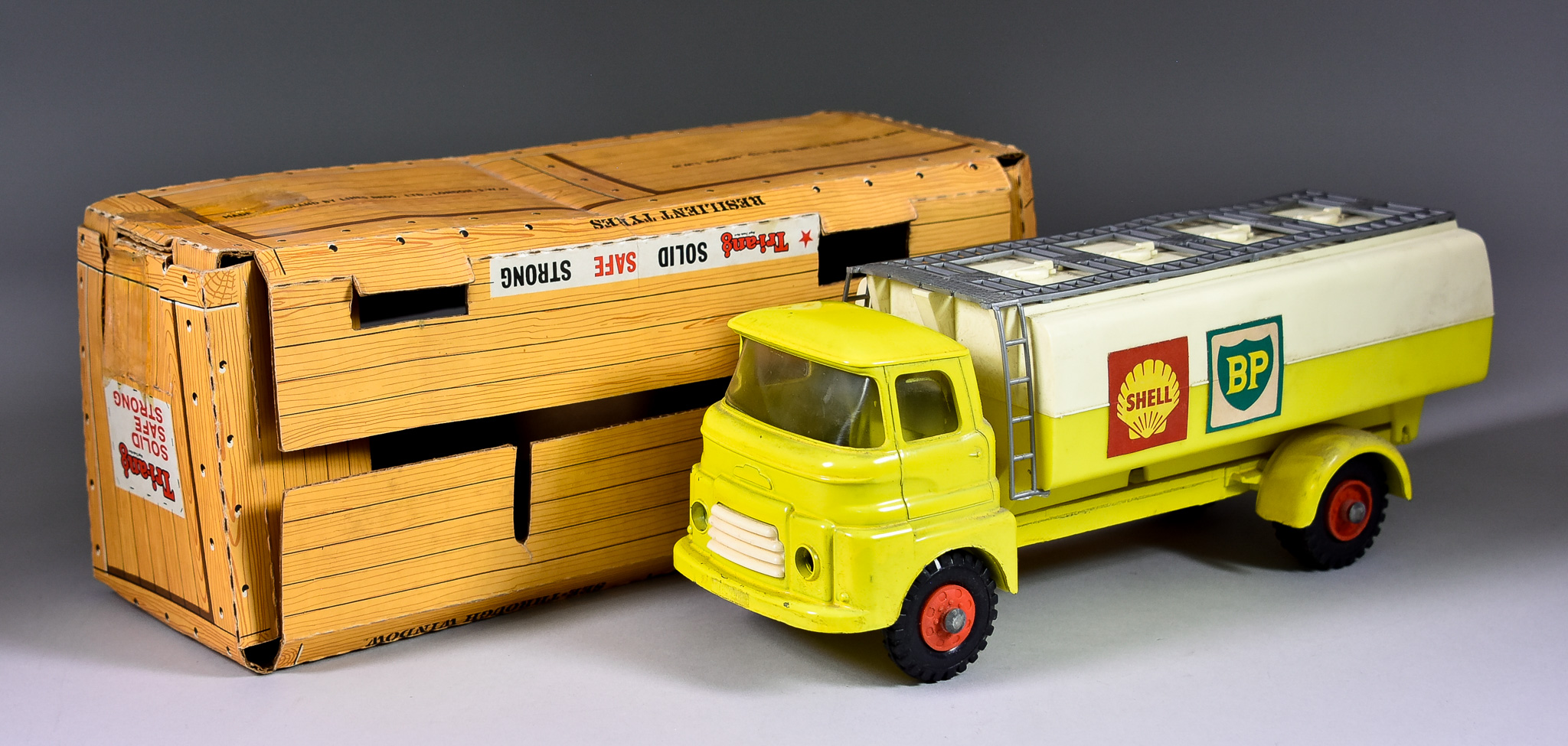 A Tri-Ang Tin Plate and Plastic Oil Tanker, with yellow cab and Shell and BP decals, 10.75ins