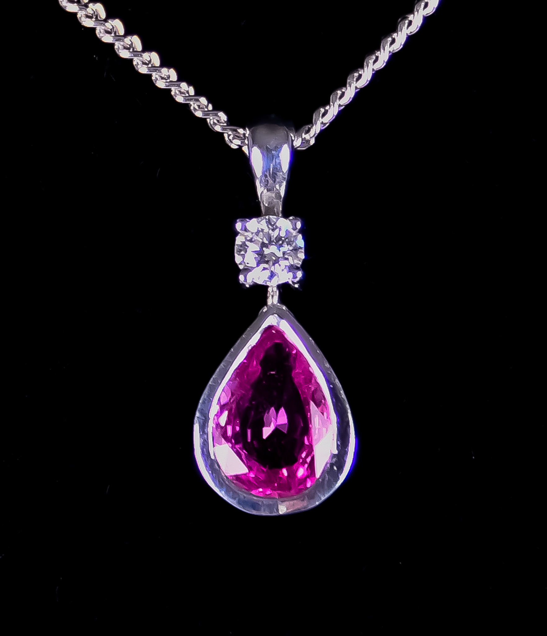 An 18ct White Gold Gem Set Pendant and Chain, 420mm overall, with suspended amethyst and faceted