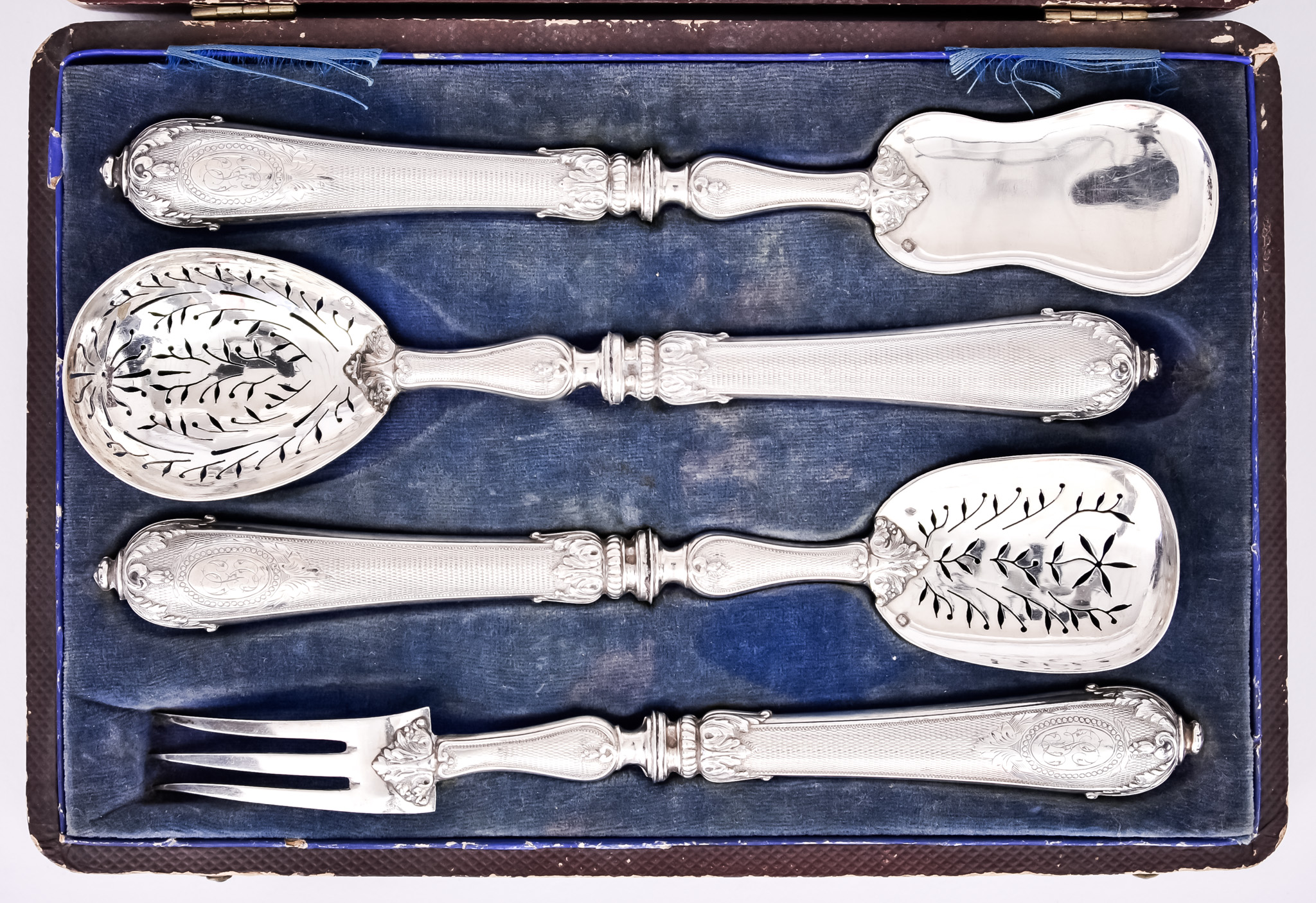 A 19th Century French Silver Four-Piece Fruit Serving Set, with leaf-capped engine turned handles,