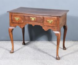 An Early 18th Century Oak Lowboy, with cross-banded and moulded edge to top, fitted three frieze