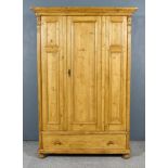 A Late 19th Century Panelled Pine Cupboard, with moulded edge to top, fitted hanging rail,