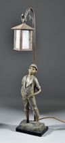 An Early 20th Century Spelter Table Lamp, modelled as a boy leaning against a lantern, 25ins high