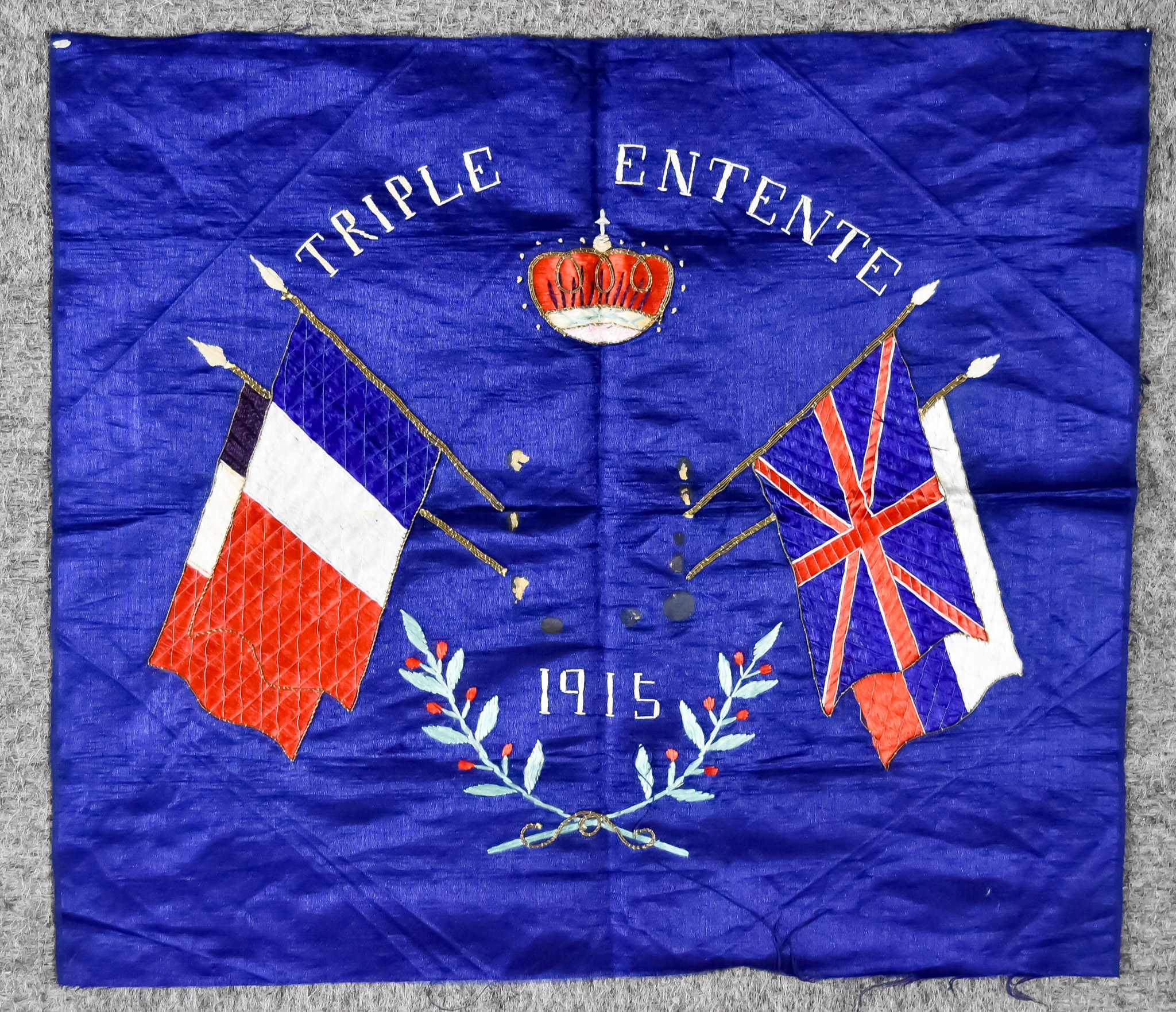 A WW I Embroidered Panel on Blue Raw Silk, 'Triple Entente 1915', 18.75ins x 23ins, together with