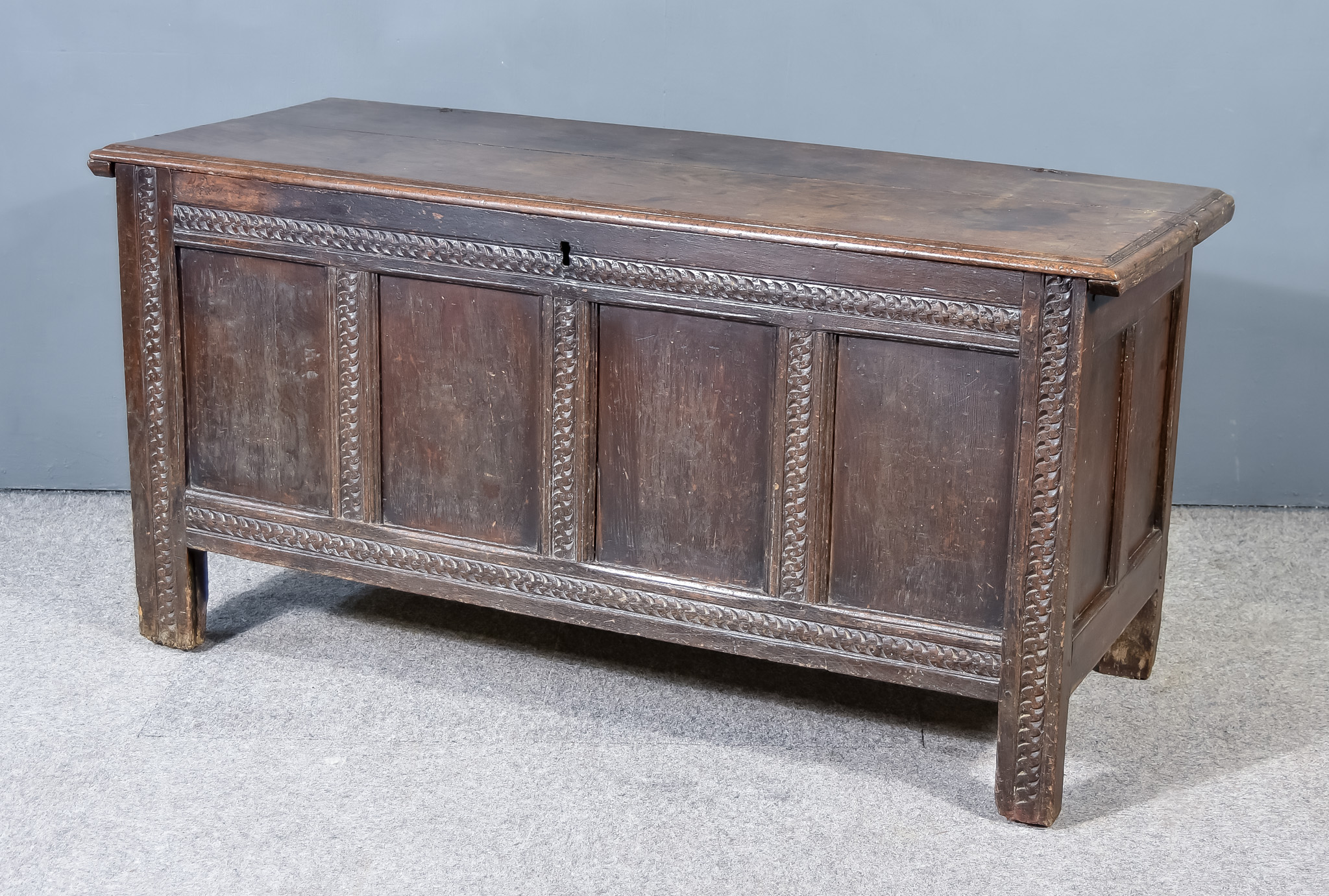 A Late 17th Century Panelled Oak Coffer, with moulded edge to top, with four fielded panels to front