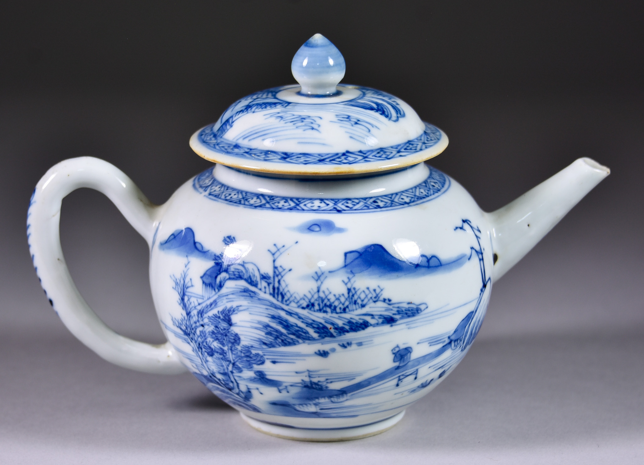 A Chinese Blue and White Porcelain Teapot and Cover, painted with a mountainous river landscape, 4.