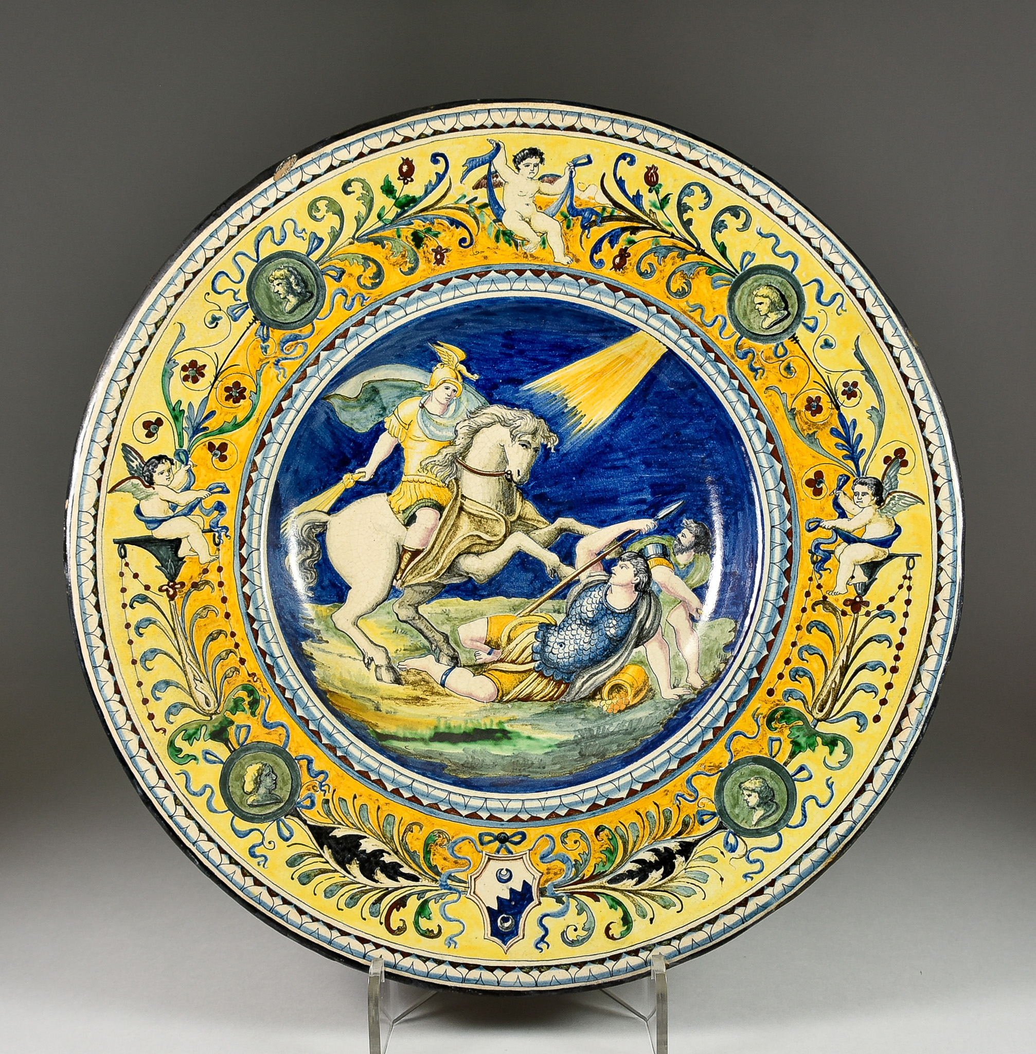 An Italian Maiolica Dish in Renaissance Style, Late 19th Century, the centre painted with a battle