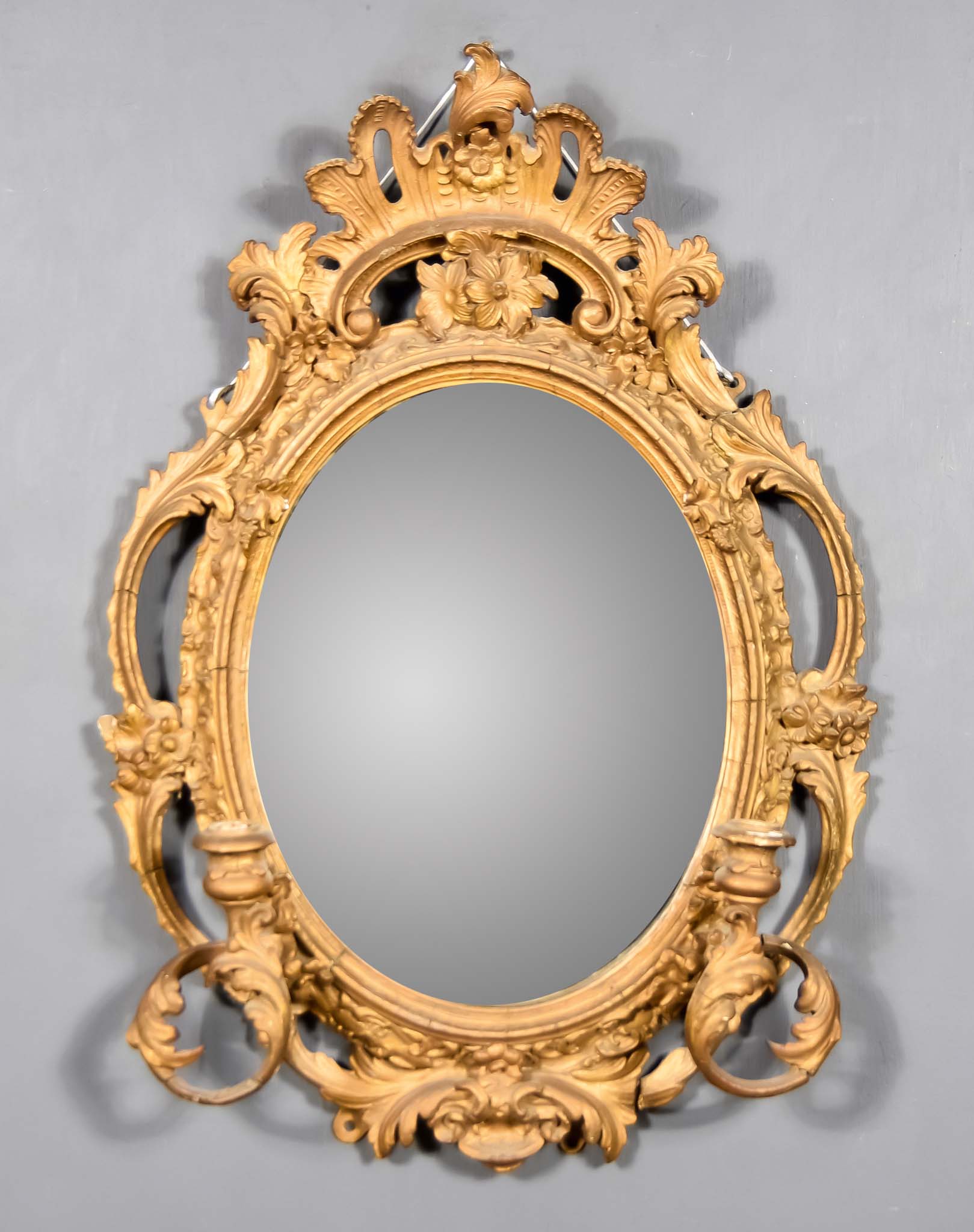 A 19th Century Gilt Framed Oval Girandole, with fretted scroll and floral frame, with two scroll