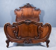 A Late 19th Century French Oak 5ft Bedstead, the head and foot board with leaf carved and scroll