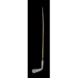 A Yellow and White Metal Stick Pin, in the form of a golf club, mounted with a small seed pearl,