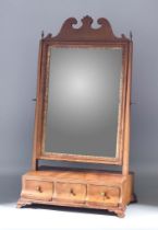 An 18th Century Walnut Toilet Mirror, with shaped cresting, gilt slip and plain mirror plate,