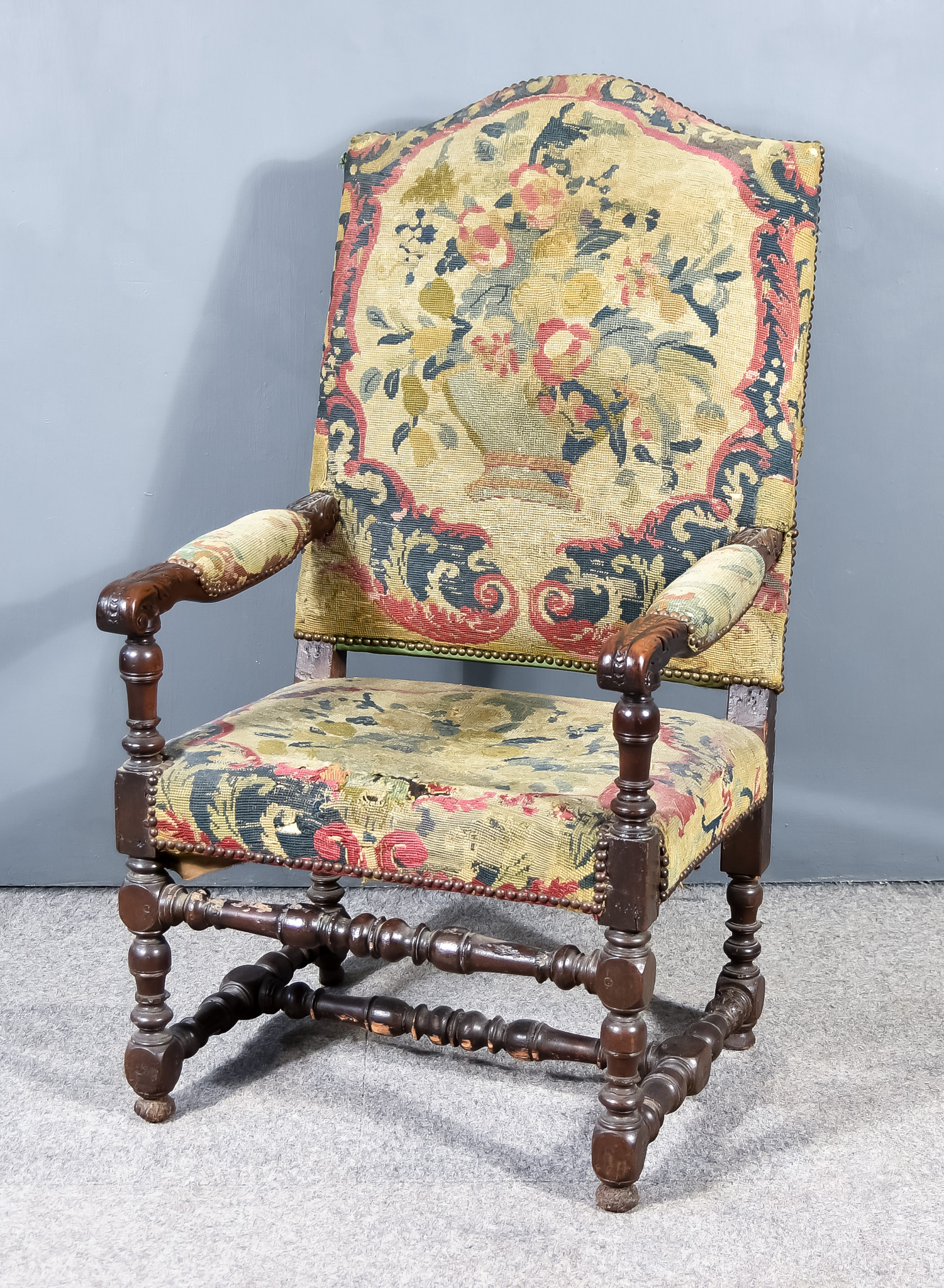 A Late 17th Century Walnut Framed High Back Open Armchair with shaped cresting, the seat and back