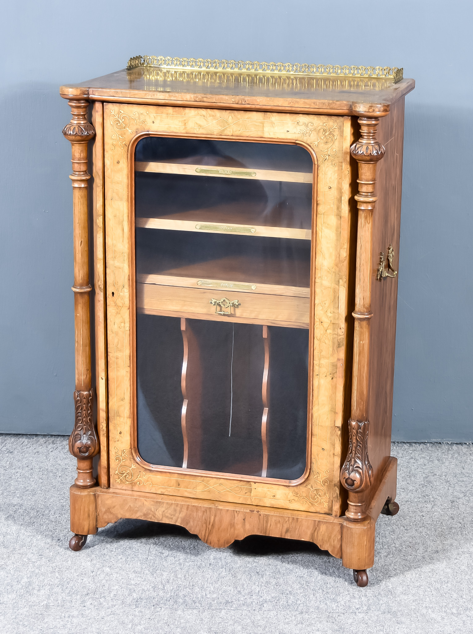 A Victorian Figured Walnut and Inlaid Music Cabinet,  of lobed outline, with pierced brass