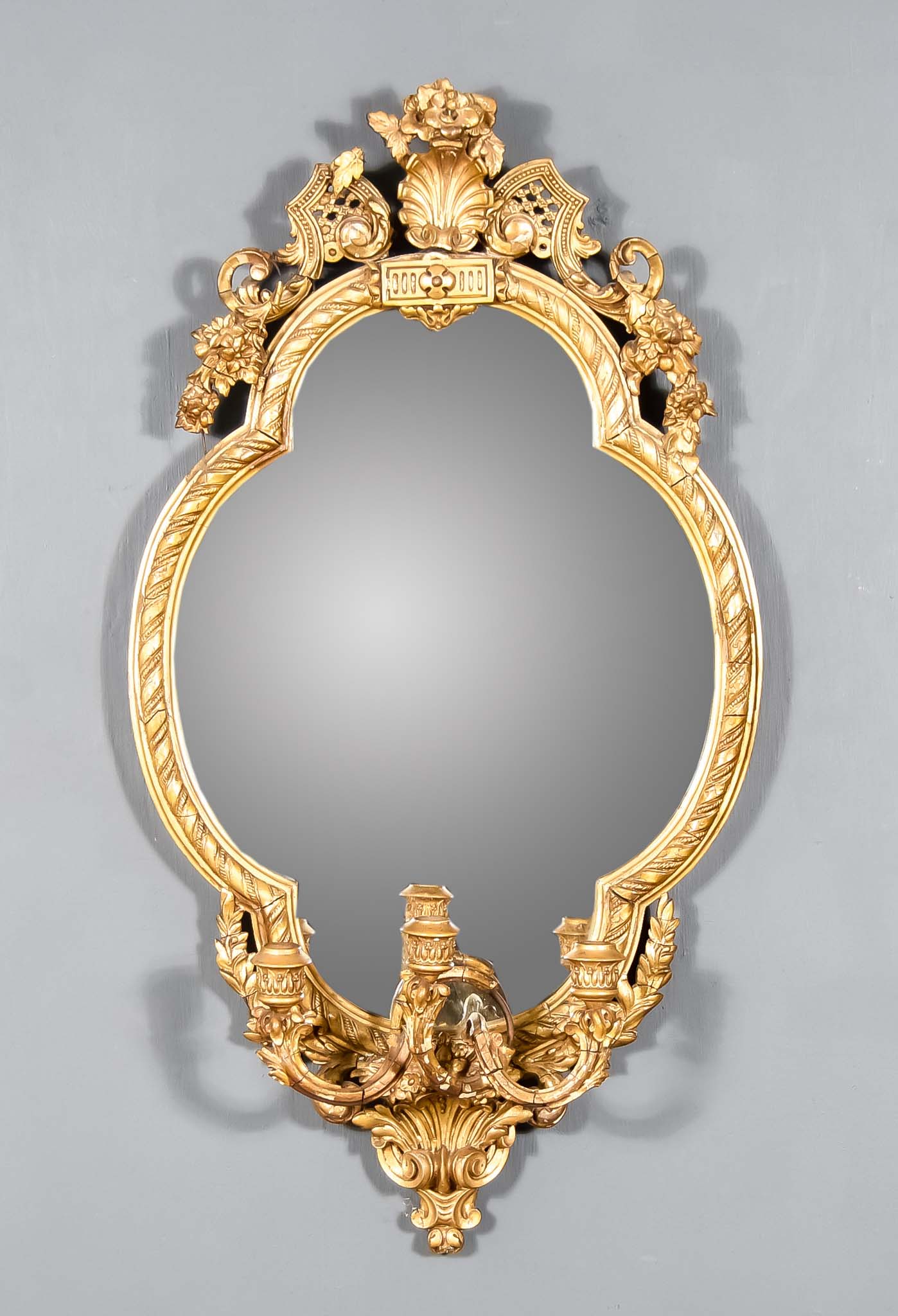 A Late 19th Century Gilt Framed Oval Girandole, with shell, floral and scroll cresting, the