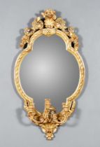 A Late 19th Century Gilt Framed Oval Girandole, with shell, floral and scroll cresting, the