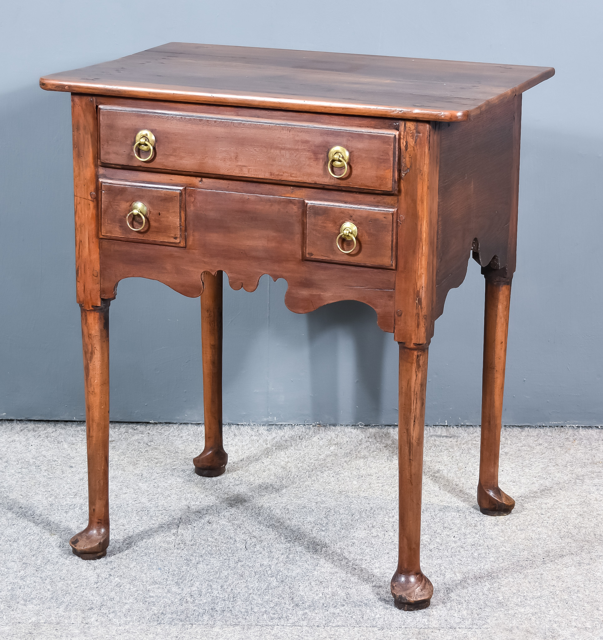 An 18th Century Walnut Lowboy, with square edge to top, fitted one real and two dummy drawers,