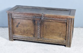 A Late 17th Century Oak Coffer, with single plank top, the front carved with roundels, on square