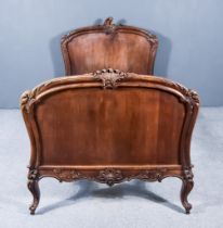 A Late 19th Century French Walnut 3ft Bedstead, the head and foot board with leaf carved and moulded