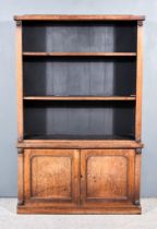 An Early Victorian Mahogany Bookcase, the upper part with shaped cresting, fitted two open