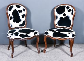 A Pair of Victorian Mahogany Framed Chairs with shaped and moulded frames, upholstered in black