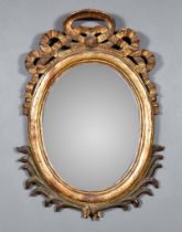 A 19th Century Gilt Framed Oval Wall Mirror, the moulded frame with bold ribbon cresting and leaf