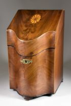 A George III Figured Mahogany Knife Box, of serpentine outline, the hinged top inlaid with central
