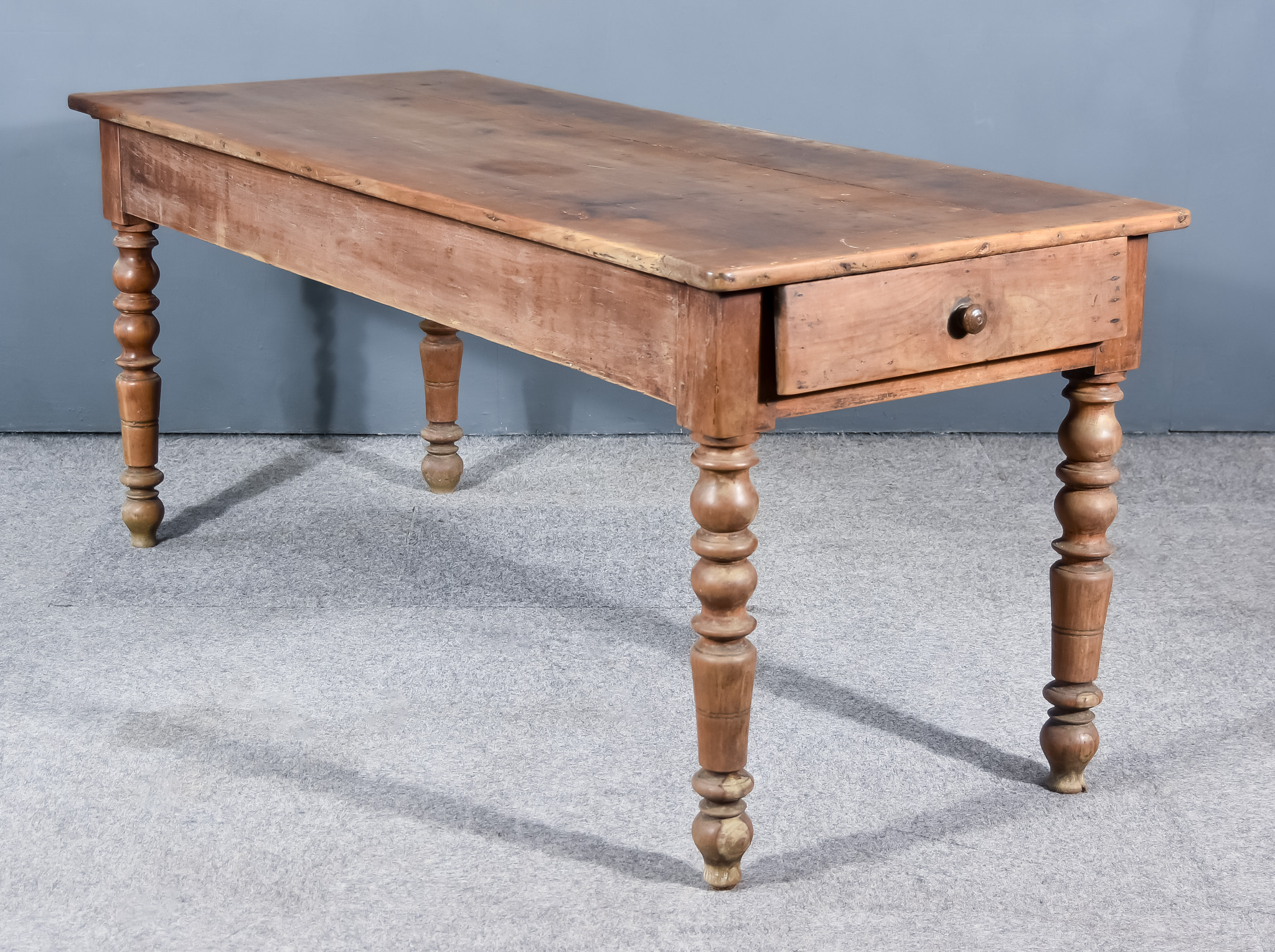 A Late 19th Century French Provincial Cherrywood Kitchen Table, the three plank top with square