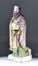 A Rennes Faience Figure of St Luke, Circa 1880/90, modelled by Vadislas Graindorge (1826-1901),